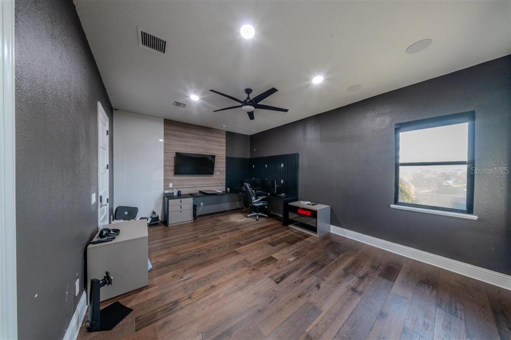 4303 Isabella Circle Windermere, FL 34786 - Photo 51 of 77 a view of a livingroom with hardwood floor and a ceiling fan