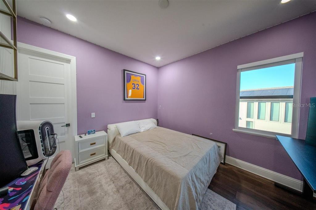 4303 Isabella Circle Windermere, FL 34786 - Photo 55 of 77 a bedroom with a bed and a bookshelf