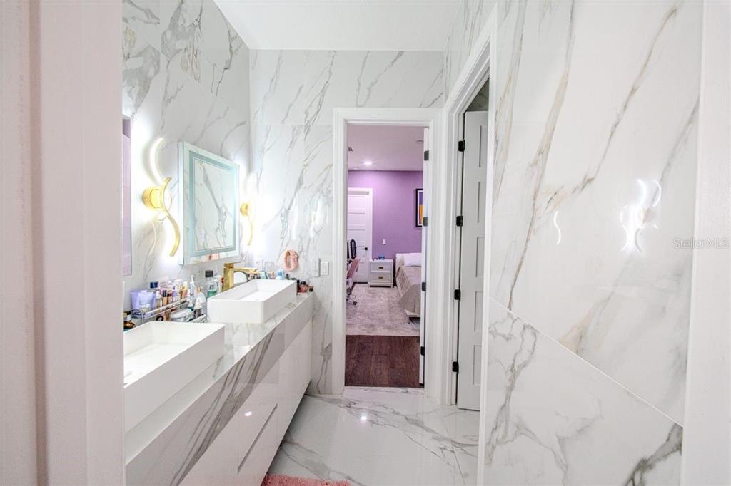 4303 Isabella Circle Windermere, FL 34786 - Photo 56 of 77 a spacious bathroom with a double vanity sink a mirror and shower