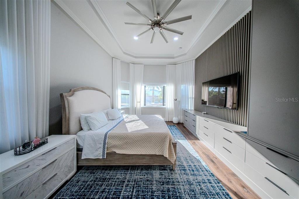 4303 Isabella Circle Windermere, FL 34786 - Photo 70 of 77 a bedroom with bed and a chandelier