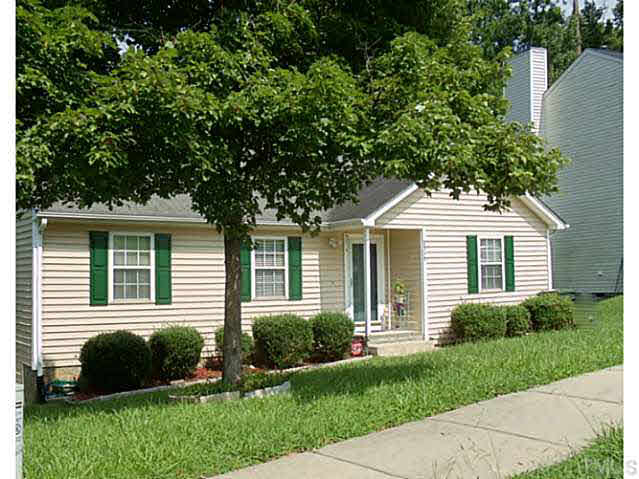 2315 Springhill Avenue Raleigh, NC 27603 - Photo 1 of 15 a front view of a house with a yard and potted plants