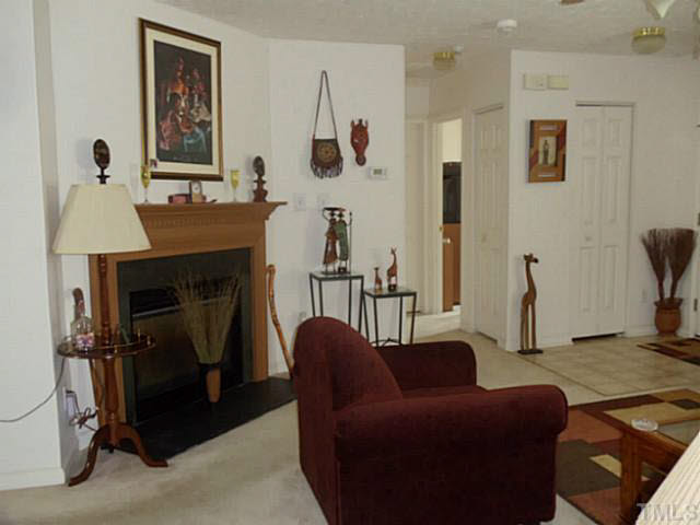 2315 Springhill Avenue Raleigh, NC 27603 - Photo 12 of 15 a living room with furniture and a fireplace