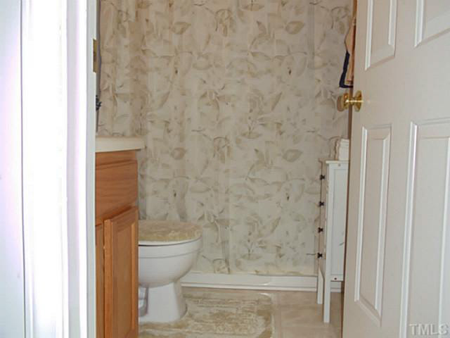 2315 Springhill Avenue Raleigh, NC 27603 - Photo 13 of 15 a bathroom with a toilet and a shower