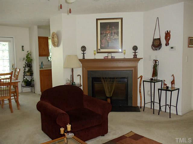 2315 Springhill Avenue Raleigh, NC 27603 - Photo 2 of 15 a living room with furniture and a fireplace