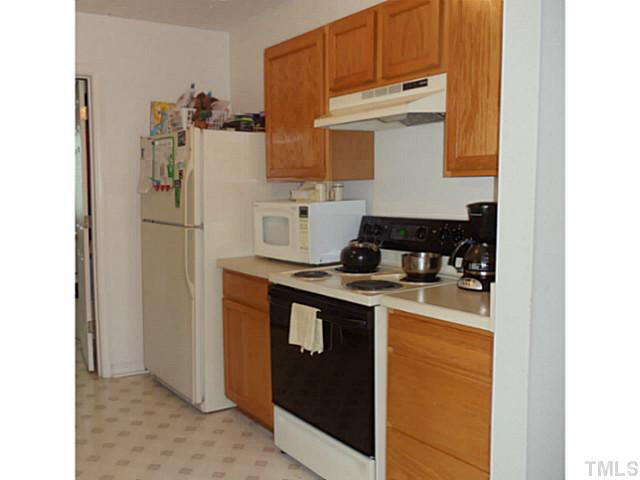 2315 Springhill Avenue Raleigh, NC 27603 - Photo 6 of 15 a kitchen with a refrigerator and a stove