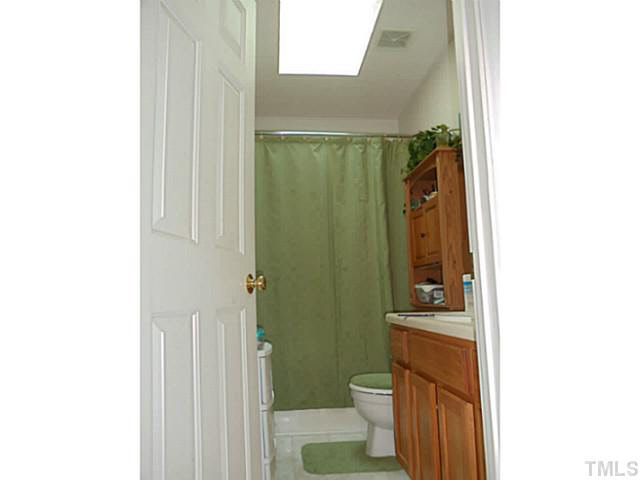 2315 Springhill Avenue Raleigh, NC 27603 - Photo 10 of 15 a bathroom with a toilet a sink and shower