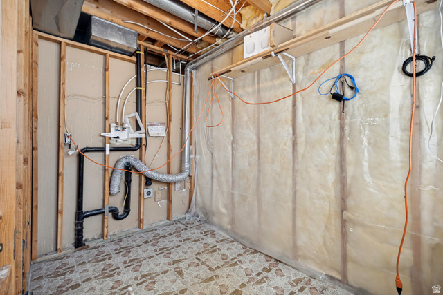 5529 Ridge Hollow Way Kearns, UT 84118 - Photo 20 of 23 Exposed wall framing with utility lines, insulated wall panels, and an unfinished ceiling