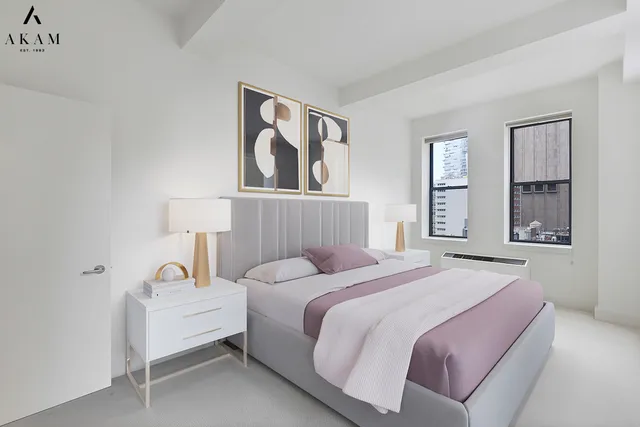 a bedroom with a bed and a lamp on the dresser