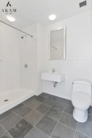 a bathroom with a toilet a sink and shower