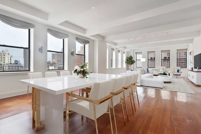 a view of a dining room with furniture large windows and wooden floor