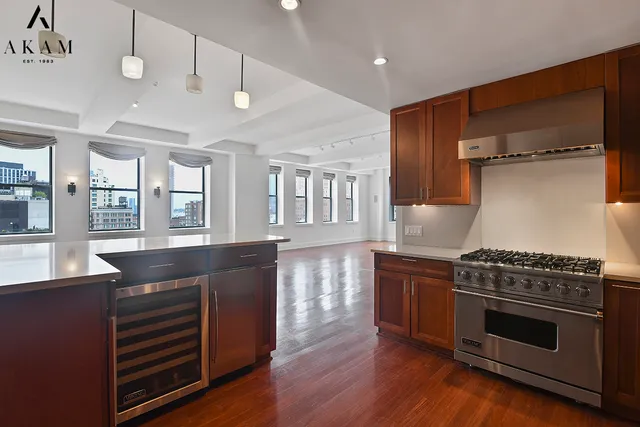 a kitchen with stainless steel appliances granite countertop a stove and a refrigerator