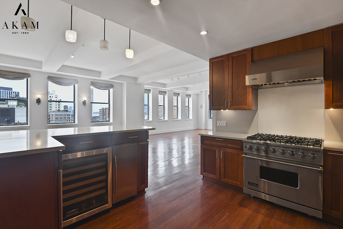 80 Chambers Street, Unit 10F Manhattan, NY 10007 - Photo 6 of 22 a kitchen with stainless steel appliances granite countertop a stove and a refrigerator