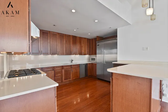 a kitchen with granite countertop a sink a stove and cabinets