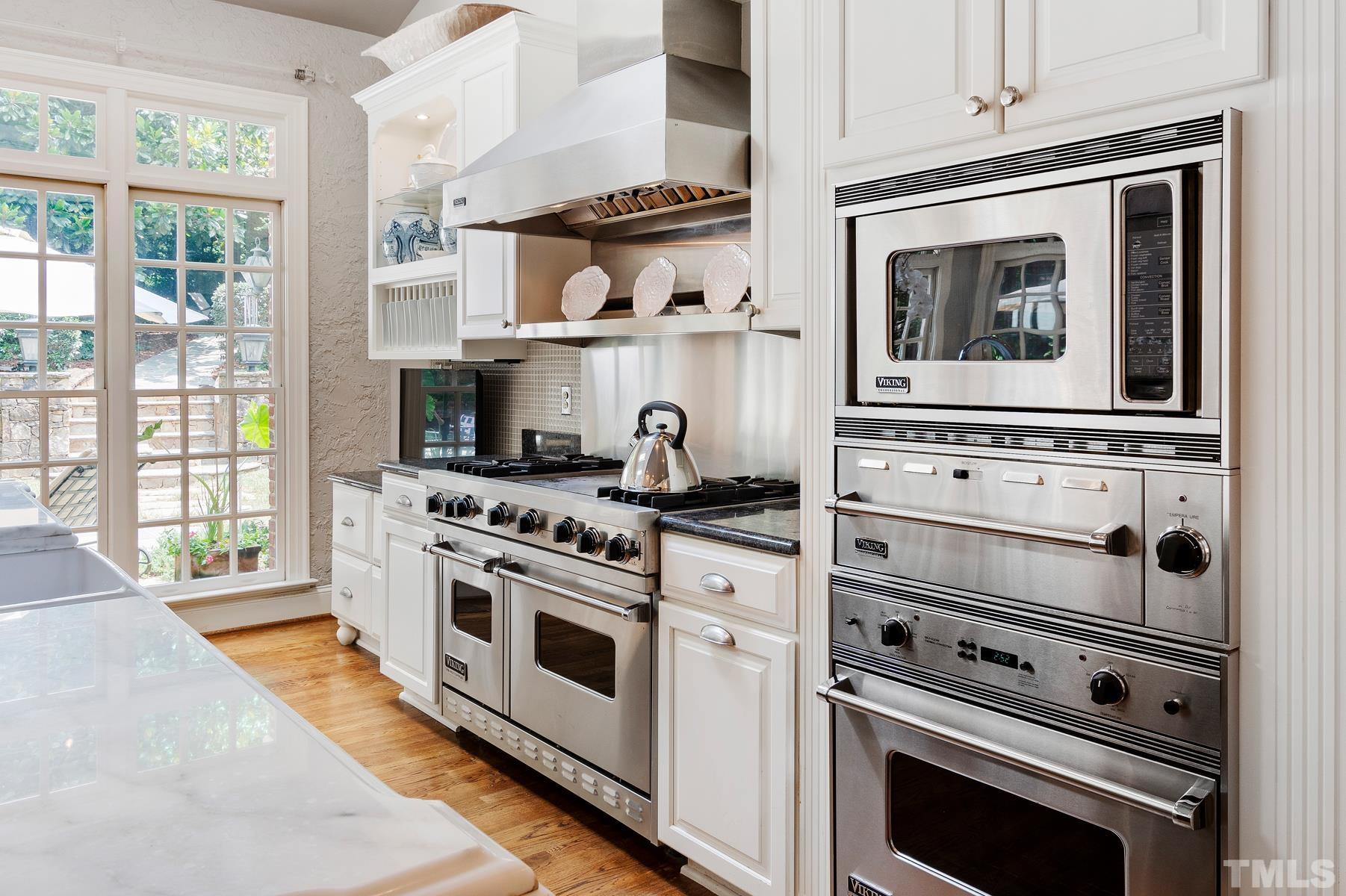 1430 Chester Road Raleigh, NC 27608 - Photo 11 of 39 a kitchen with appliances cabinets and a stove