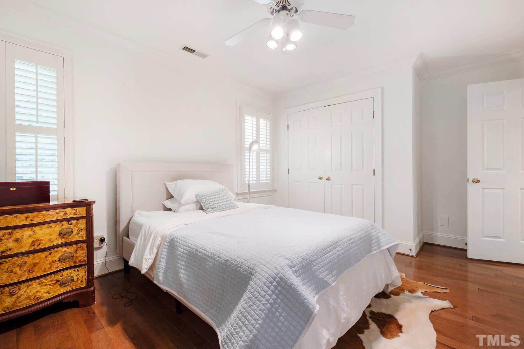 1430 Chester Road Raleigh, NC 27608 - Photo 23 of 39 a bedroom with a bed and wooden floor