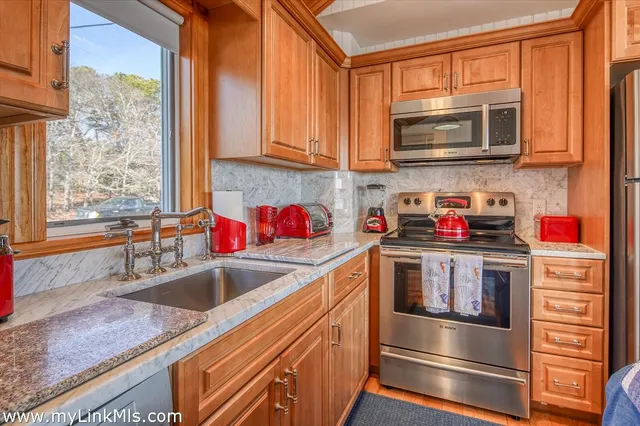 a kitchen with stainless steel appliances granite countertop a sink and a microwave