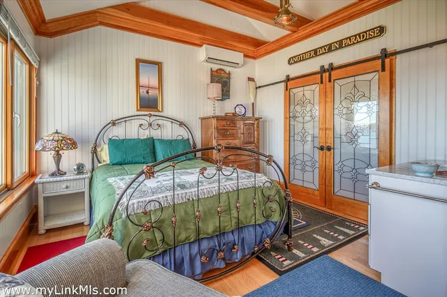 a bedroom with two beds and large window