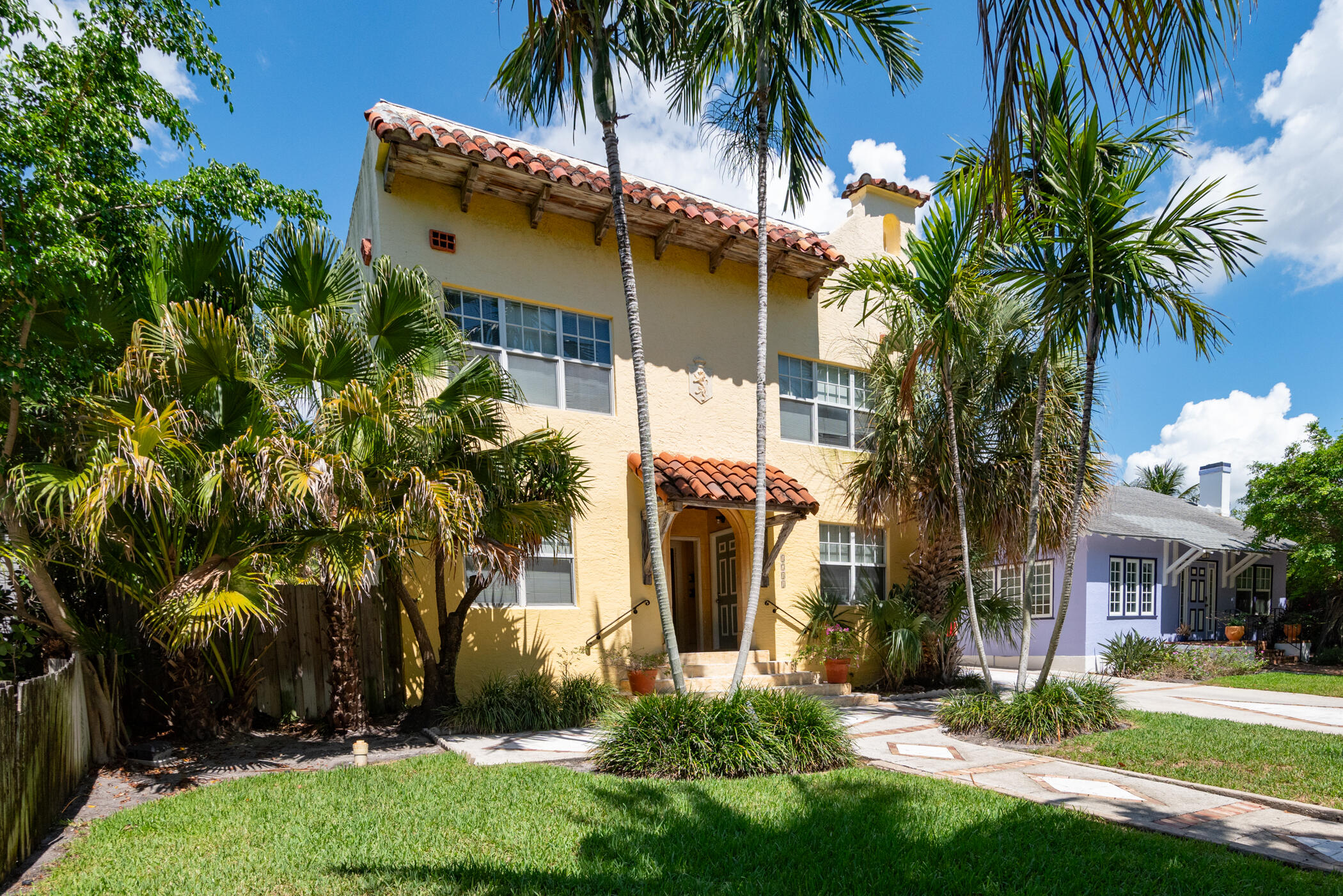 1711 Florida Avenue, Unit 4 West Palm Beach, FL 33401 - Photo 2 of 4 front view of house with a yard and palm trees