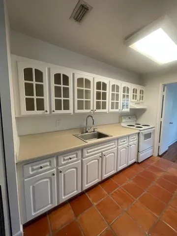 a kitchen with stainless steel appliances granite countertop a sink and cabinets