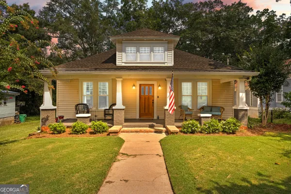 a front view of a house with a yard table and chairs