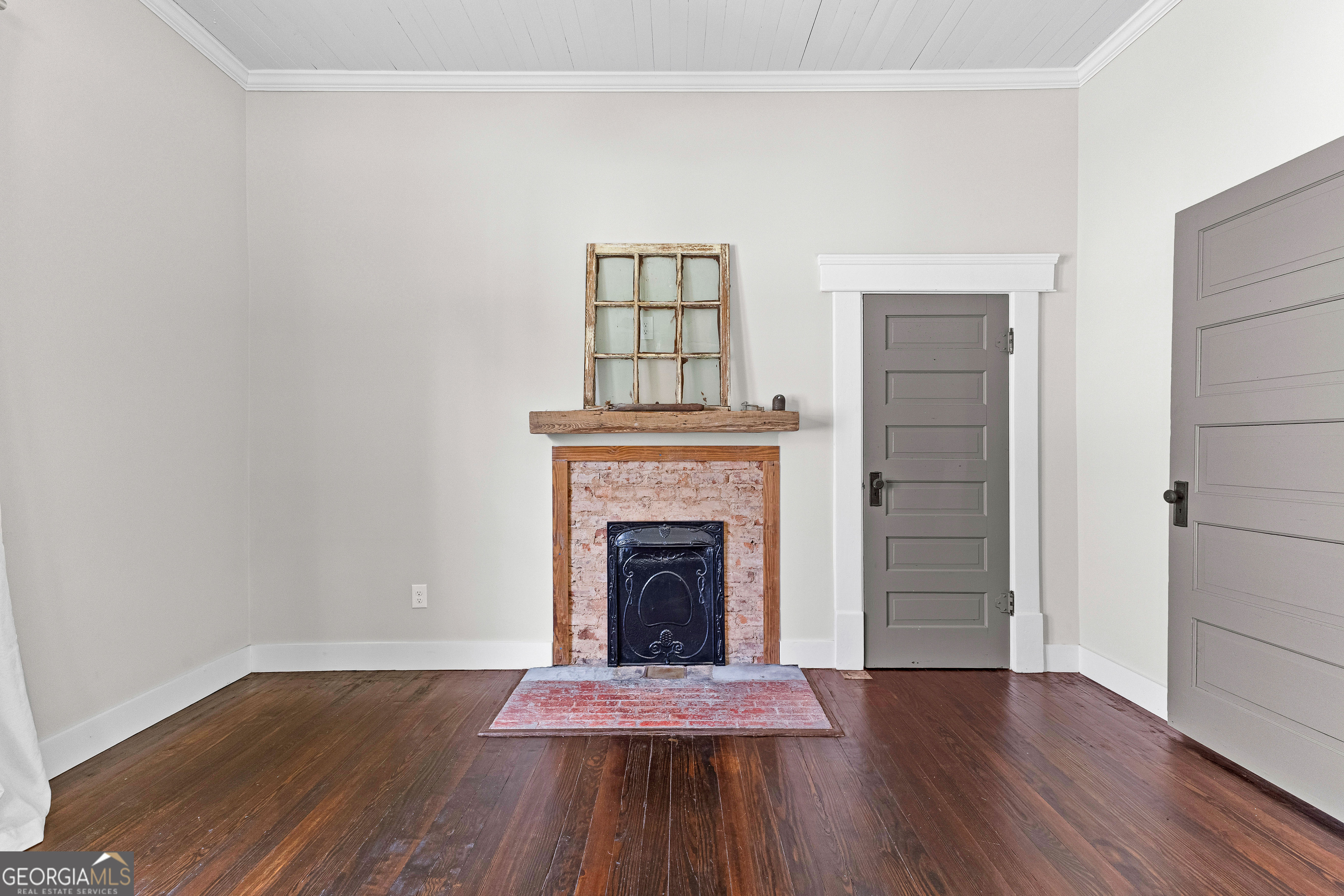 96 Griffin Street Grantville, GA 30220 - Photo 17 of 63 a living room with a fireplace and wooden floor