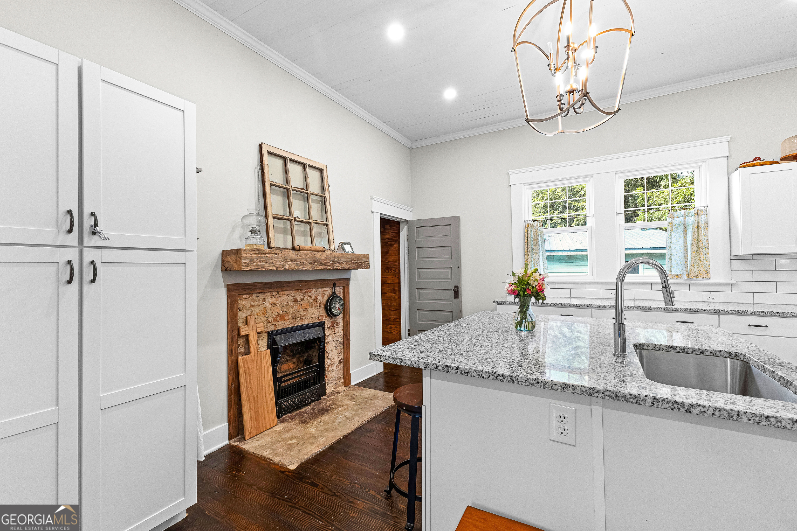 96 Griffin Street Grantville, GA 30220 - Photo 27 of 63 a kitchen with granite countertop a stove a sink and a chandelier