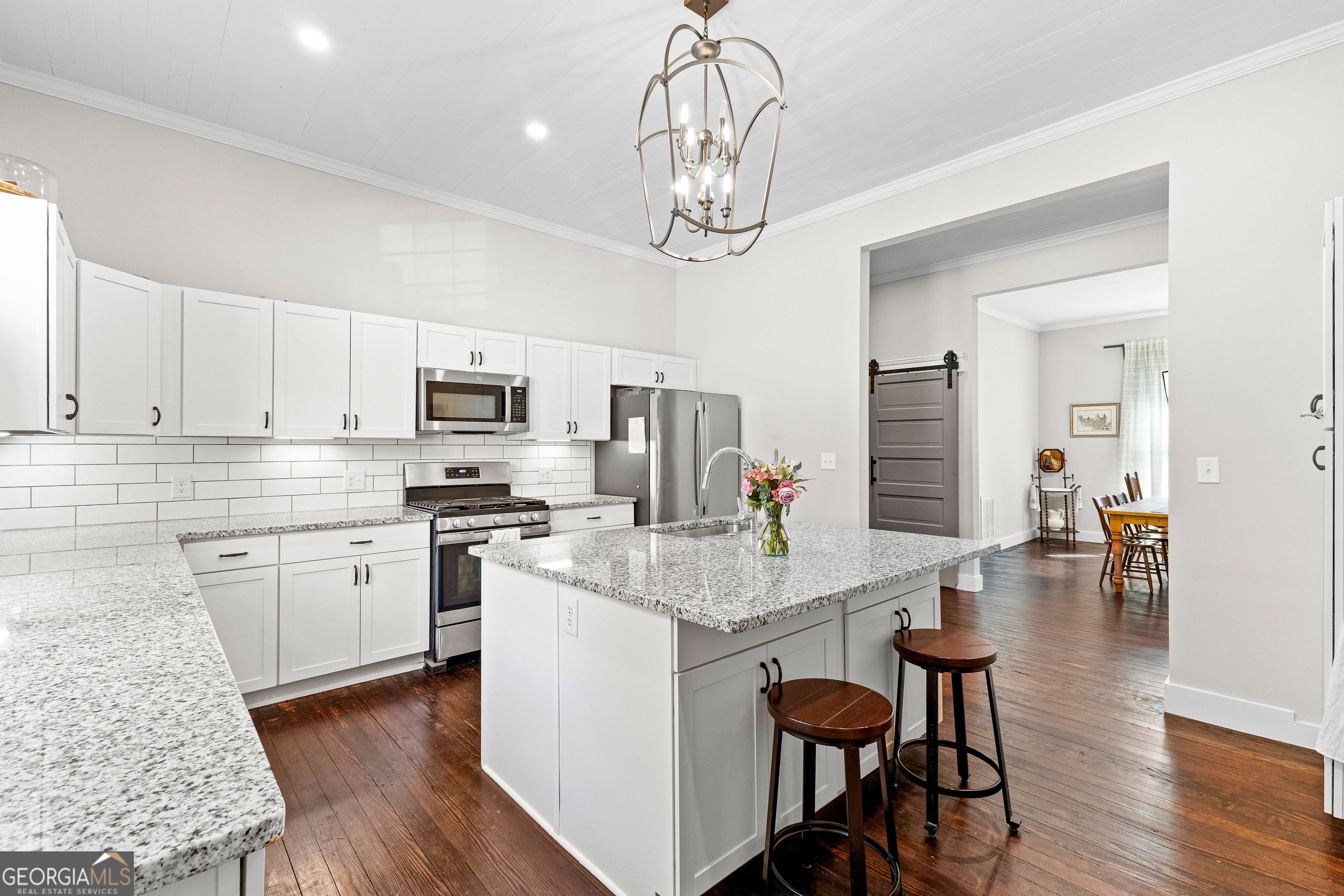 96 Griffin Street Grantville, GA 30220 - Photo 28 of 63 a open kitchen with stainless steel appliances granite countertop a stove refrigerator dining table and chairs