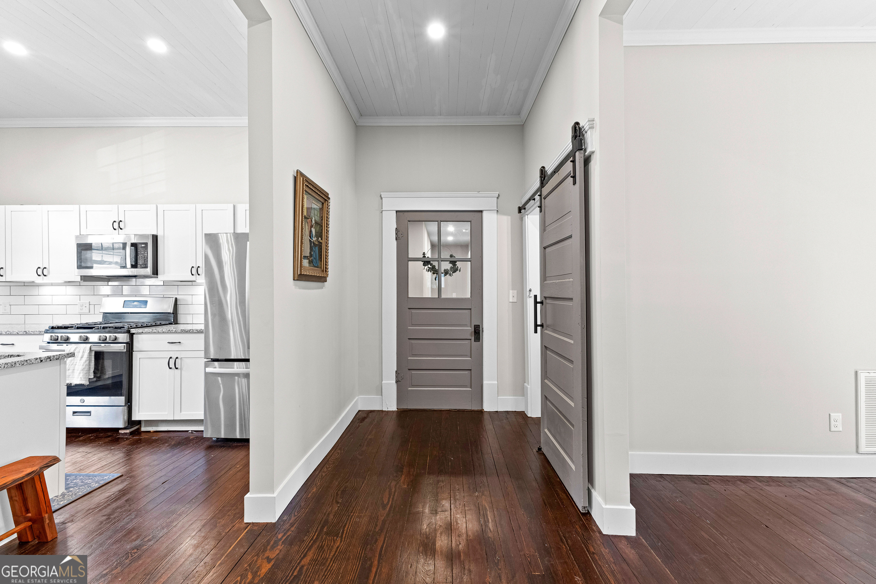 96 Griffin Street Grantville, GA 30220 - Photo 31 of 63 a view of a kitchen with a refrigerator a stove top oven and wooden floor