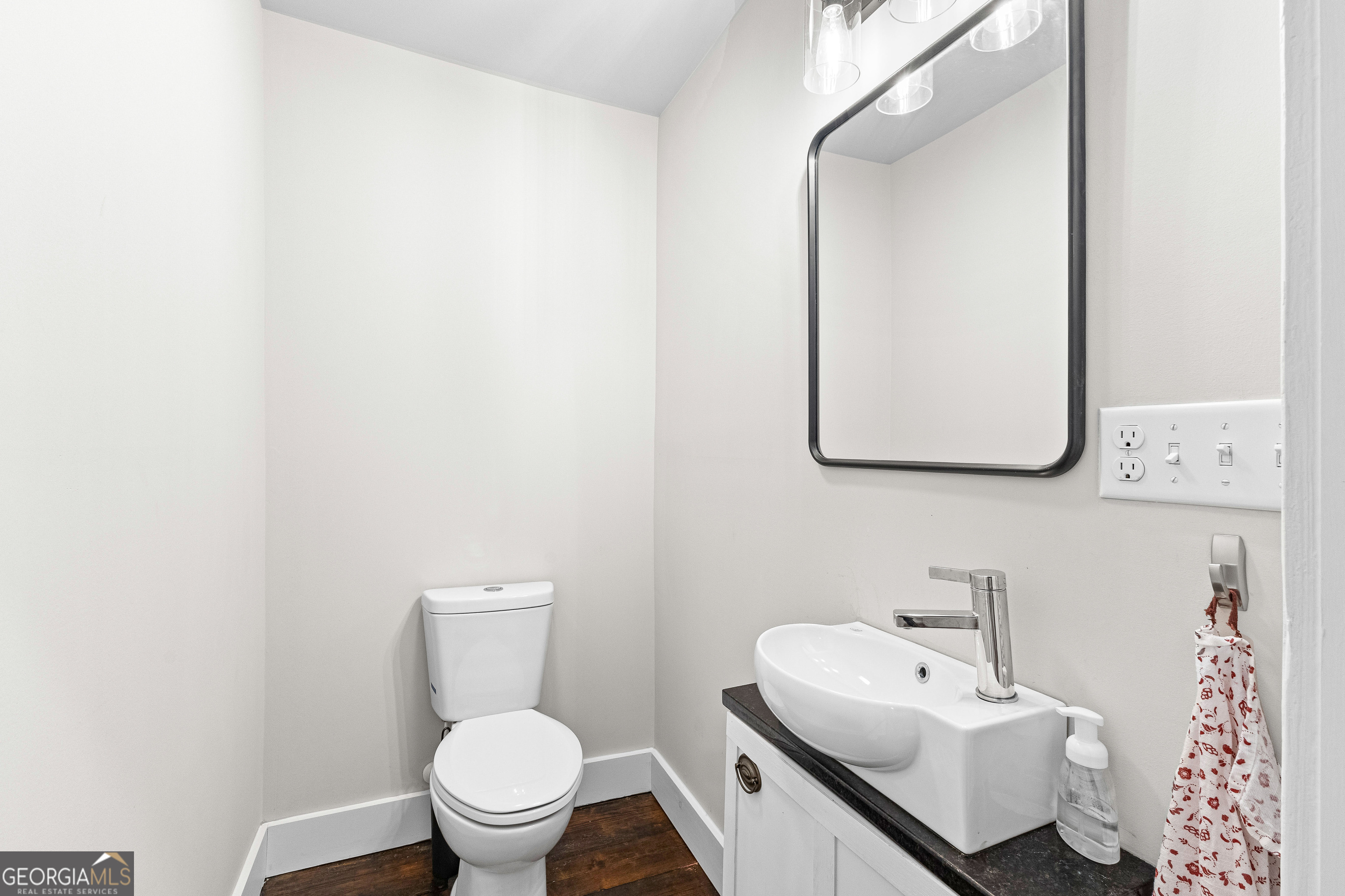 96 Griffin Street Grantville, GA 30220 - Photo 34 of 63 a bathroom with a toilet sink and mirror