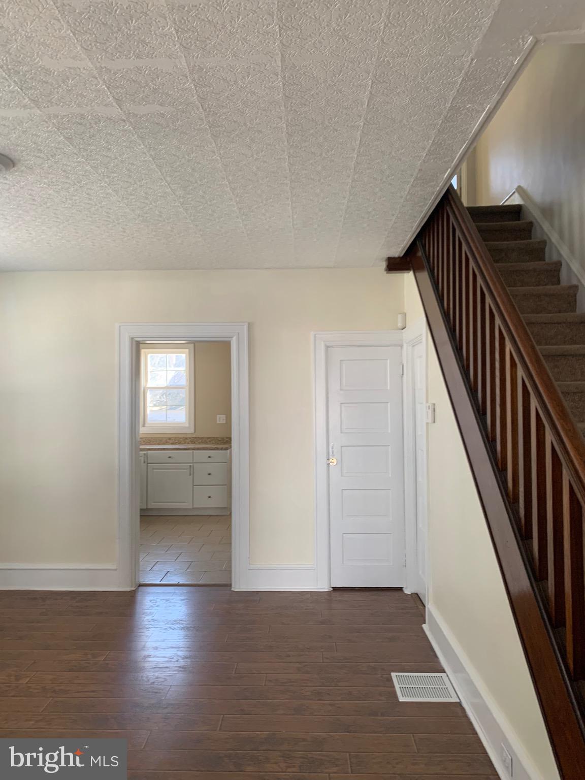 119 Grandview Avenue Pitman, NJ 08071 - Photo 7 of 28 a view of an empty room with wooden floor and stairs