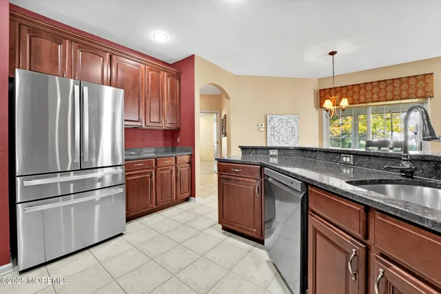 a kitchen with stainless steel appliances granite countertop a refrigerator sink and cabinets