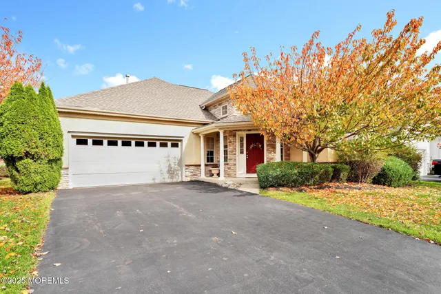 a view of a house with a yard and potted plants