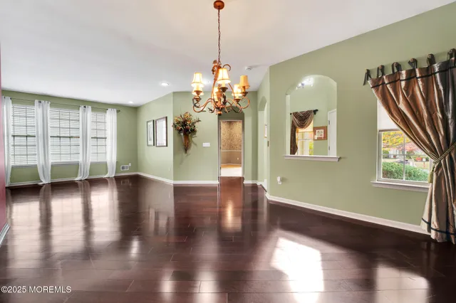 a view of a big room with wooden floor windows and a kitchen