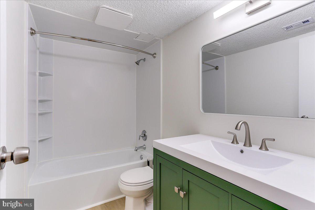 11823 Breton Court, Unit 2B Reston, VA 20191 - Photo 18 of 21 a bathroom with a sink toilet and shower
