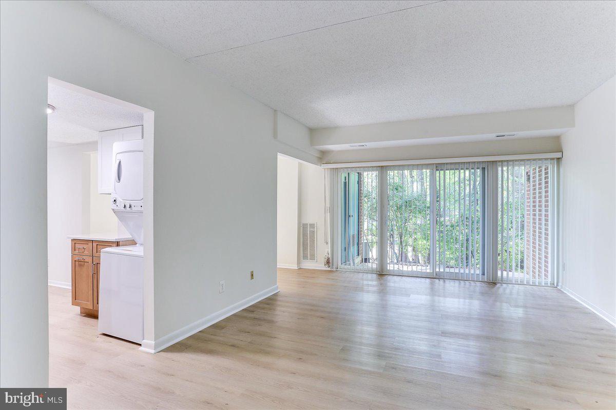 11823 Breton Court, Unit 2B Reston, VA 20191 - Photo 5 of 21 a view of an empty room with wooden floor and a window