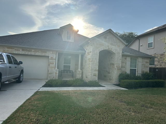 2313 Bridges Ranch Road Georgetown, TX 78628 - Photo 1 of 2 A classic stone facade and inviting arched entryway create an impressive curb appeal.