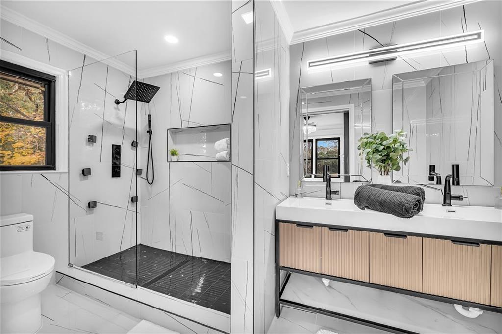 1306 Poplarcrest Circle Southeast Atlanta, GA 30316 - Photo 12 of 24 a bathroom with a shower sink and toilet