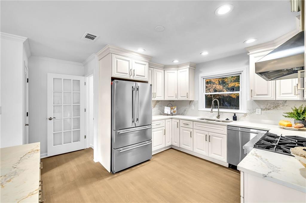 1306 Poplarcrest Circle Southeast Atlanta, GA 30316 - Photo 9 of 24 a kitchen with white cabinets and white appliances