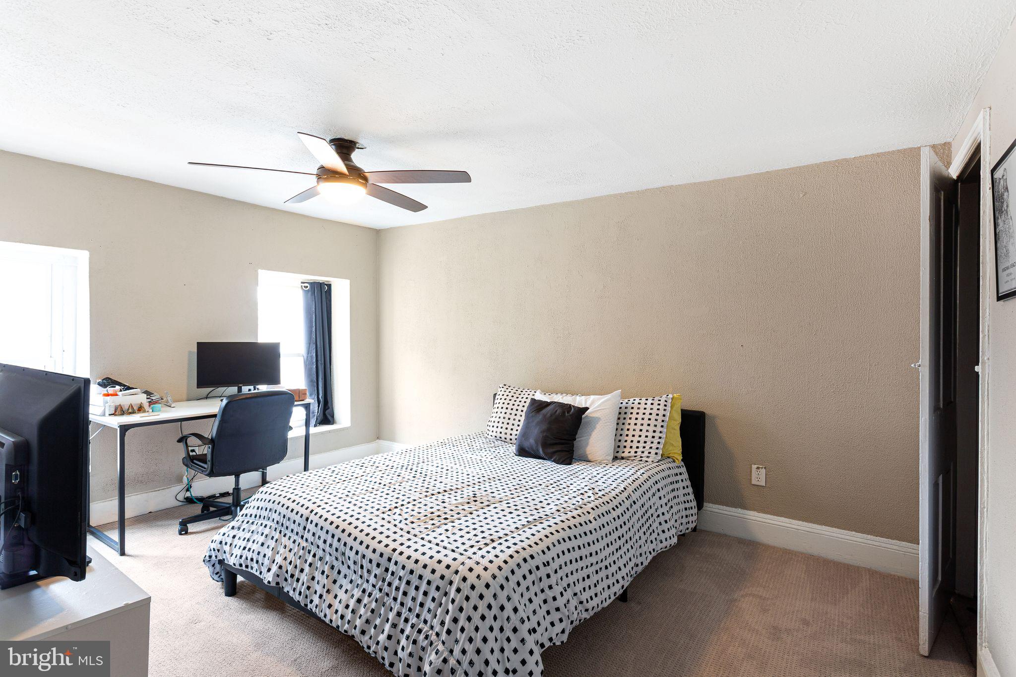 140 Wendover Street Philadelphia, PA 19127 - Photo 11 of 16 a bedroom with a bed and a flat screen tv