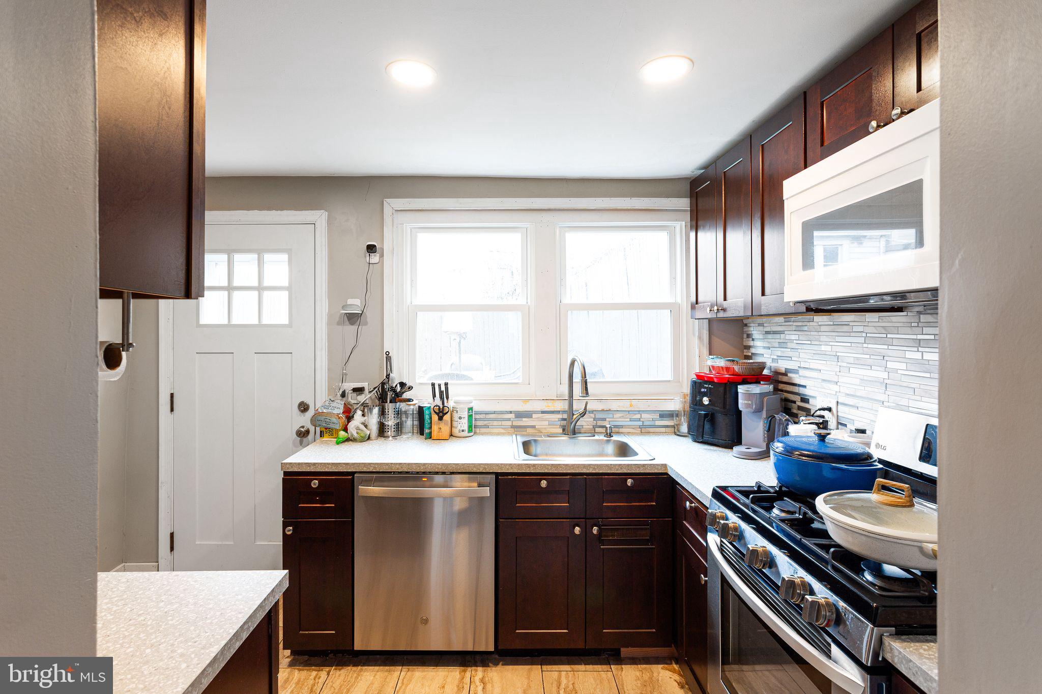 140 Wendover Street Philadelphia, PA 19127 - Photo 3 of 16 a kitchen with a sink stove and cabinets