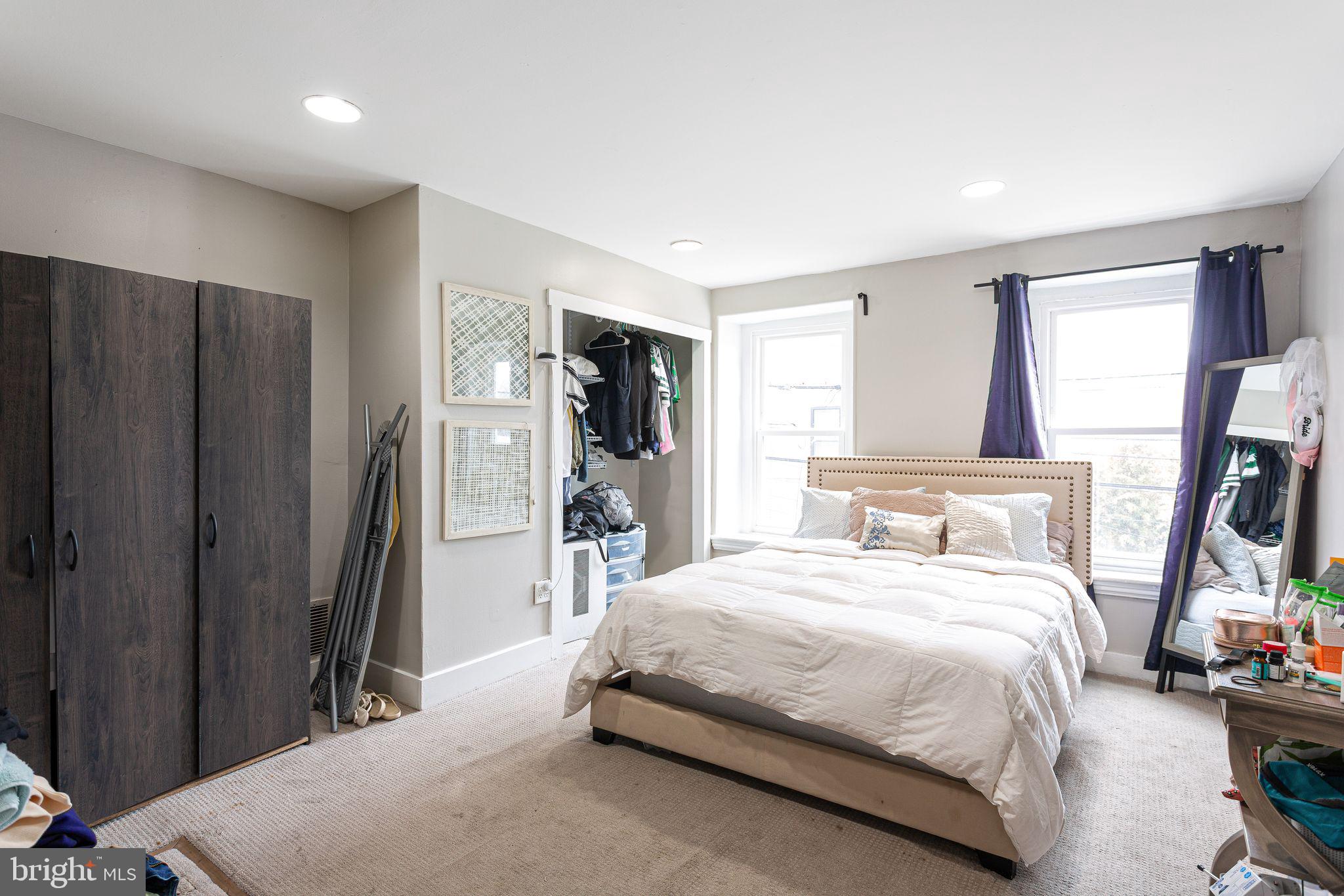 140 Wendover Street Philadelphia, PA 19127 - Photo 6 of 16 a bedroom with a bed closet and a flat tv screen