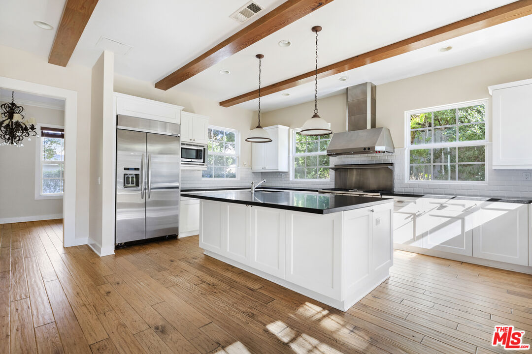 28930 Hampton Place Malibu, CA 90265 - Photo 12 of 55 a kitchen with stainless steel appliances kitchen island granite countertop a stove and a sink