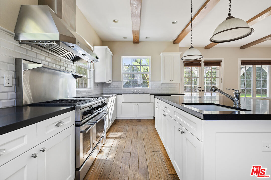 28930 Hampton Place Malibu, CA 90265 - Photo 14 of 55 a kitchen with stainless steel appliances granite countertop a sink stove and cabinets