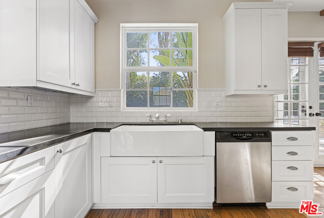 28930 Hampton Place Malibu, CA 90265 - Photo 16 of 55 a kitchen with granite countertop white cabinets and white appliances