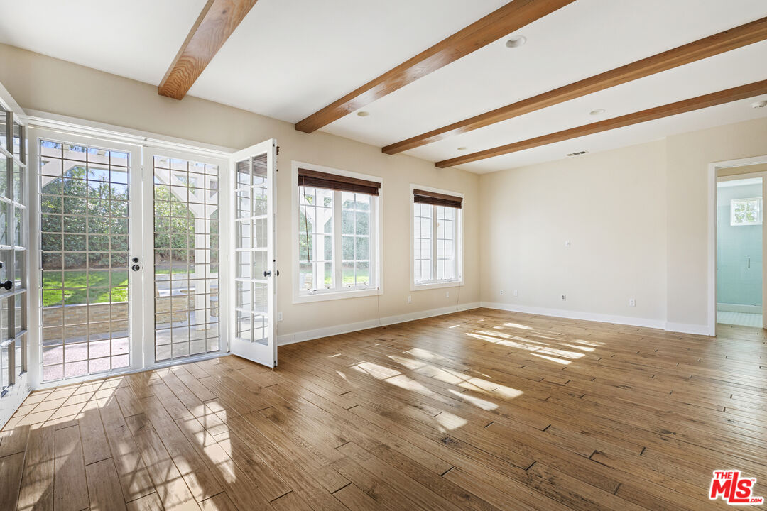 28930 Hampton Place Malibu, CA 90265 - Photo 20 of 55 a view of an empty room with wooden floor and a window