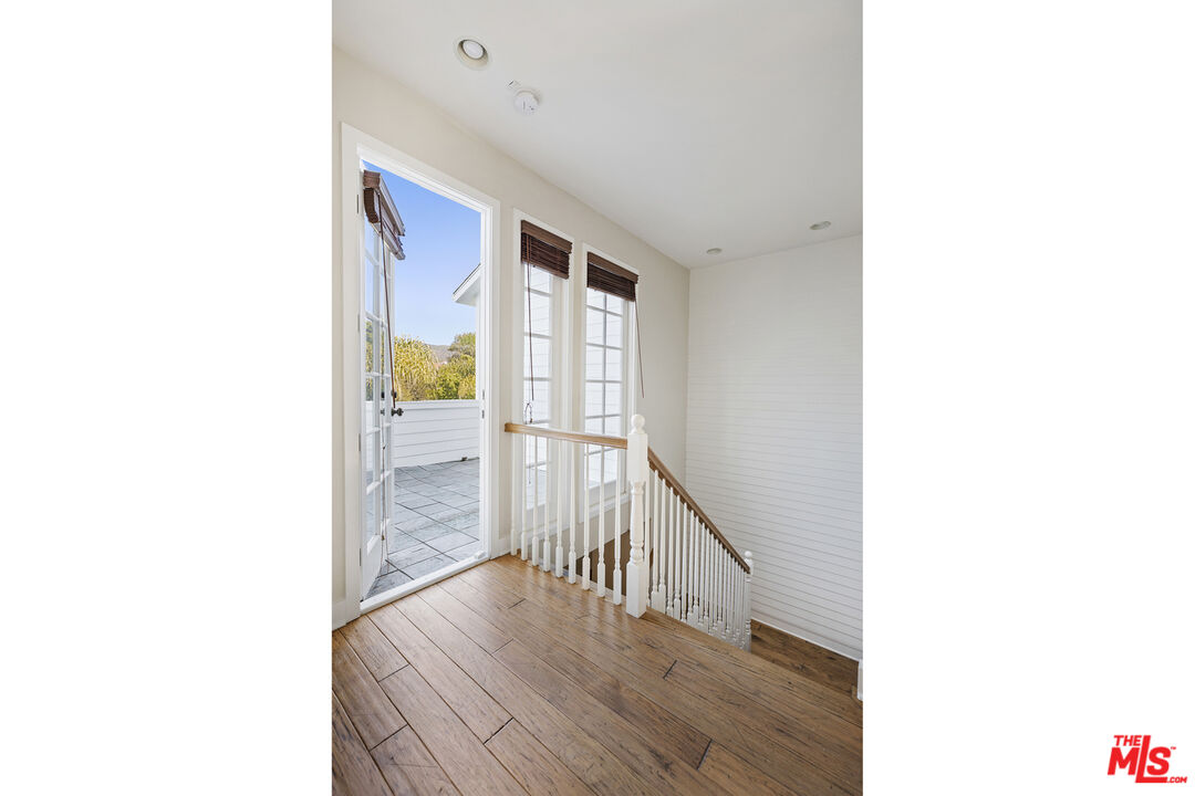 28930 Hampton Place Malibu, CA 90265 - Photo 24 of 55 a view of a hallway with wooden floor and furniture