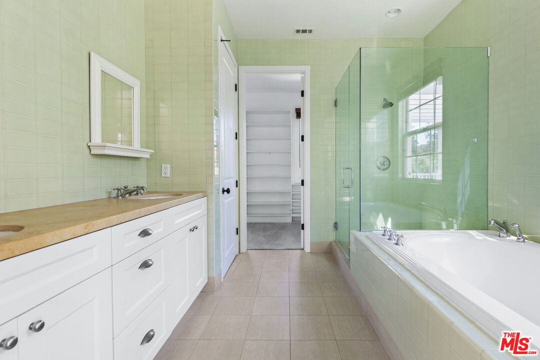 28930 Hampton Place Malibu, CA 90265 - Photo 33 of 55 a spacious bathroom with a tub sink shower and mirror