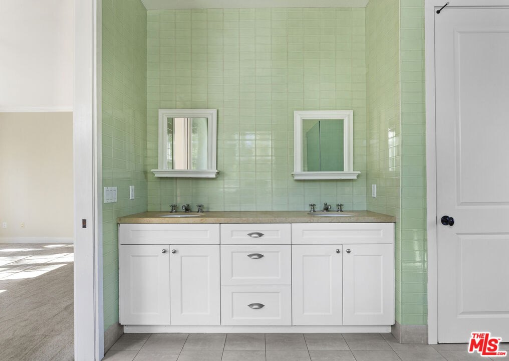 28930 Hampton Place Malibu, CA 90265 - Photo 35 of 55 a bathroom with a double vanity sink and a mirror