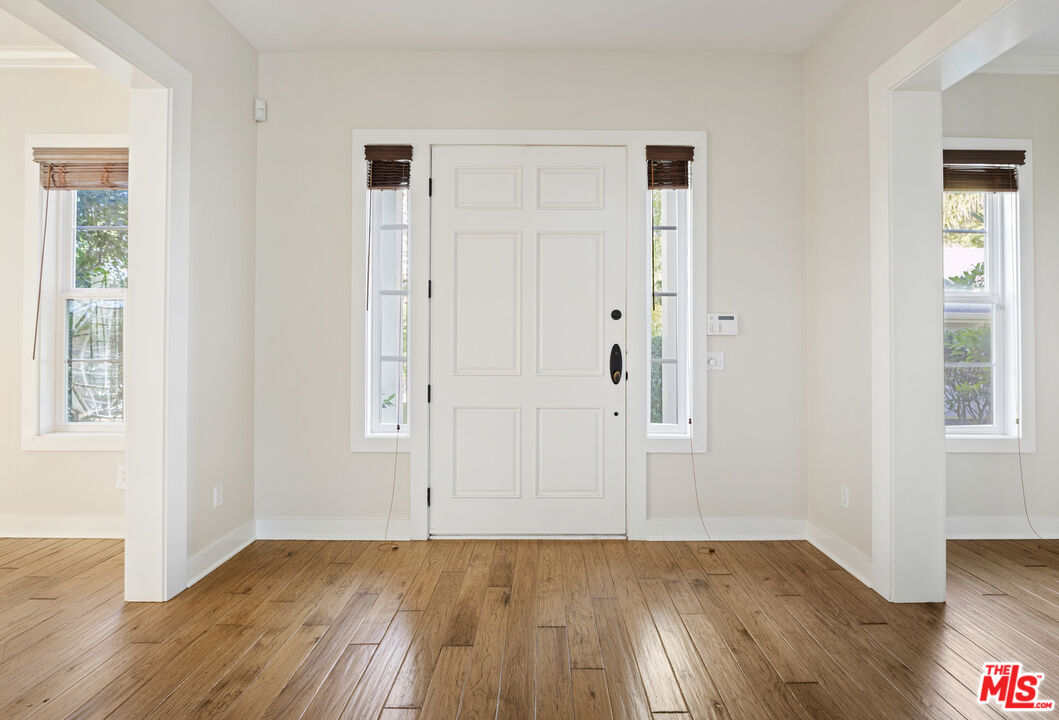 28930 Hampton Place Malibu, CA 90265 - Photo 4 of 55 an empty room with wooden floor and windows