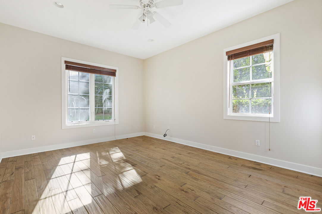 28930 Hampton Place Malibu, CA 90265 - Photo 47 of 55 an empty room with wooden floor cabinet and windows